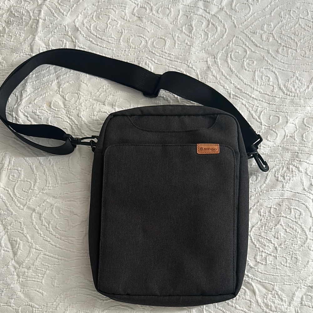 Black Travel Bag with Adjustable Strap and Durable Fabric